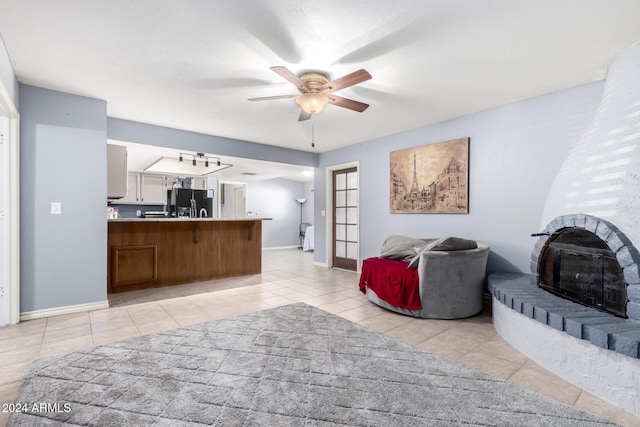 living room with ceiling fan and light tile patterned floors