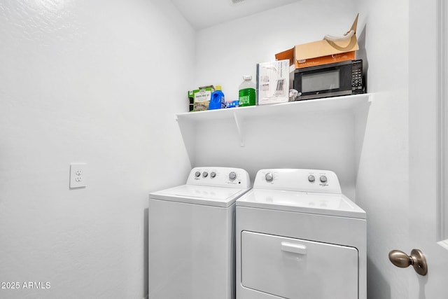 washroom with washing machine and clothes dryer