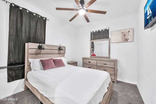 bedroom featuring ceiling fan and dark carpet