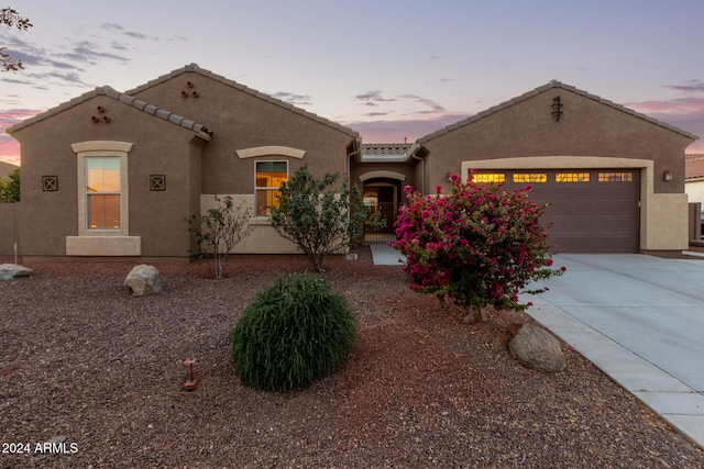 mediterranean / spanish-style home featuring a garage