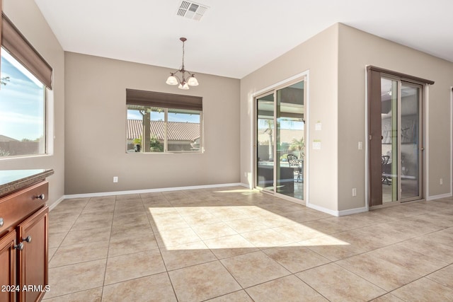 interior space with a chandelier and light tile patterned floors