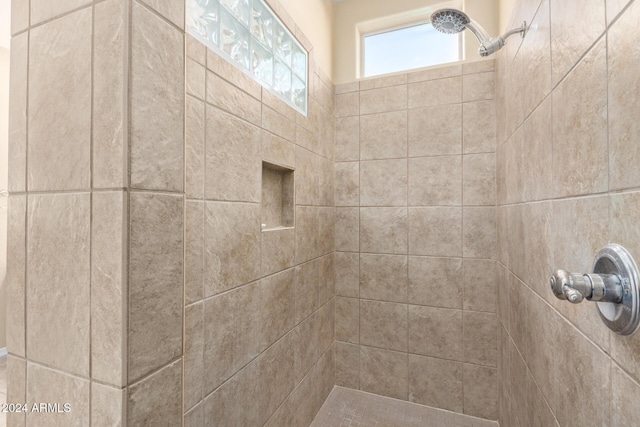 bathroom with a tile shower