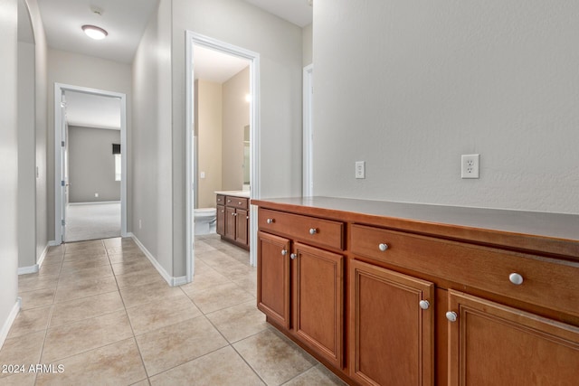 bathroom with tile patterned floors, vanity, and toilet