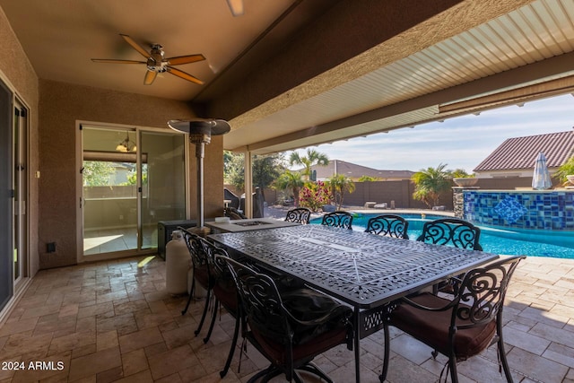 view of patio / terrace with a mountain view, a fenced in pool, and ceiling fan