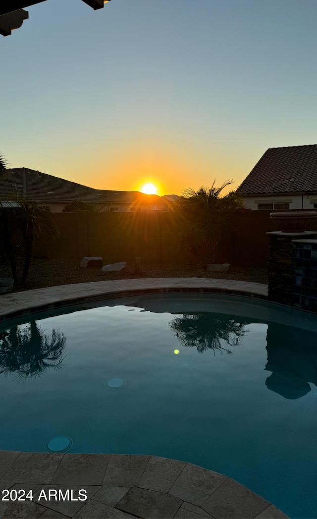 view of pool at dusk