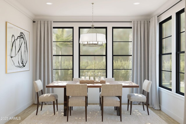 dining space with crown molding and light hardwood / wood-style floors