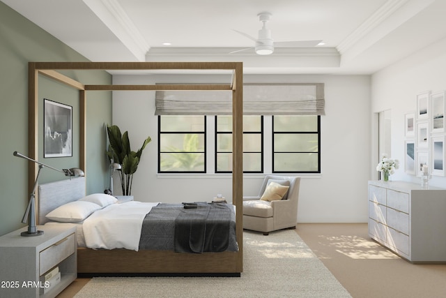 bedroom with ornamental molding, a tray ceiling, and light carpet