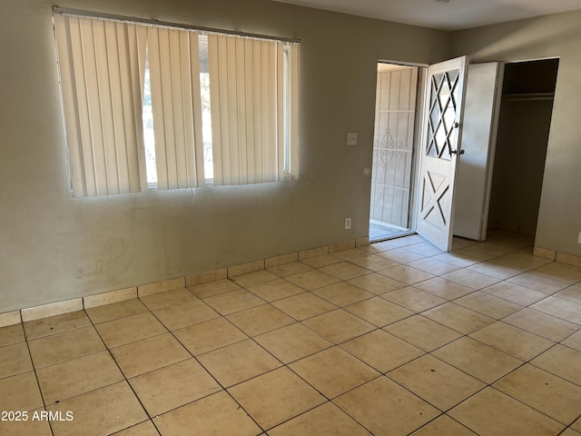 interior space featuring a closet and light tile patterned flooring