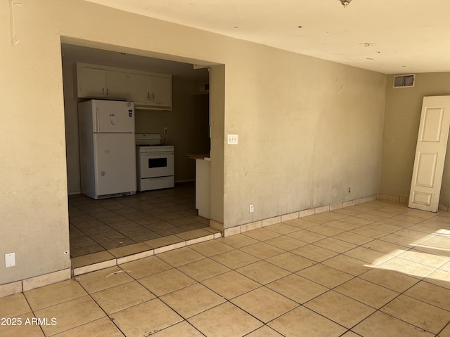 empty room with light tile patterned floors and visible vents