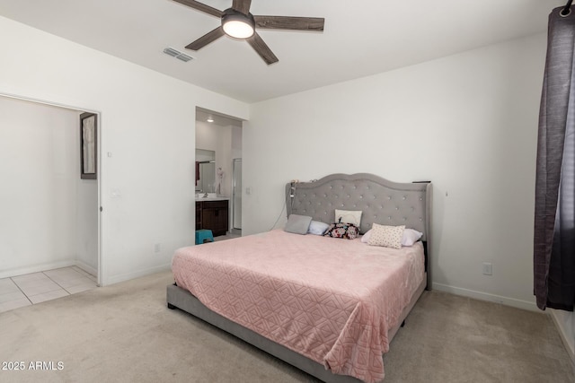 carpeted bedroom featuring baseboards, connected bathroom, tile patterned floors, and ceiling fan
