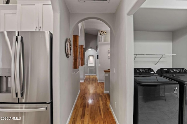 interior space with hardwood / wood-style flooring and washing machine and clothes dryer