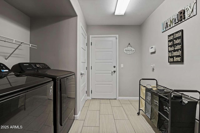 clothes washing area with washing machine and clothes dryer