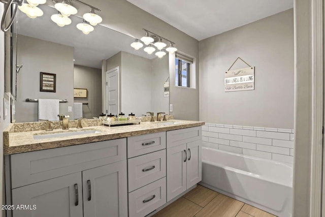 bathroom with vanity and a tub