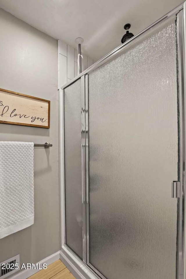 bathroom featuring walk in shower and hardwood / wood-style flooring