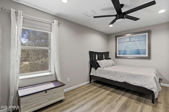 bedroom featuring ceiling fan and light hardwood / wood-style flooring