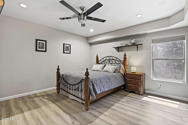 bedroom with ceiling fan and light hardwood / wood-style floors