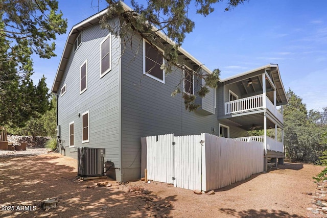 view of property exterior with a balcony, central AC unit, and ceiling fan