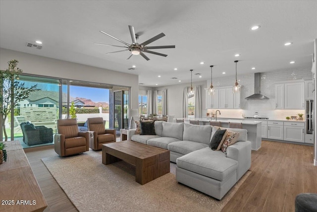 5860 E Sanford St, Mesa, AZ 85215 - living room with visible vents, ceiling fan, recessed lighting, and light wood finished floors