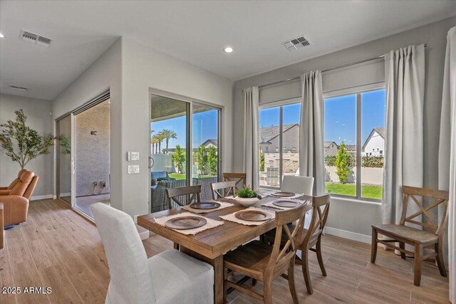 5860 E Sanford St, Mesa, AZ 85215 - dining area featuring light wood-style floors, baseboards, visible vents, and a wealth of natural light