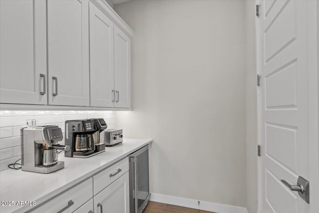 5860 E Sanford St, Mesa, AZ 85215 - bar featuring backsplash, baseboards, beverage cooler, and wood finished floors