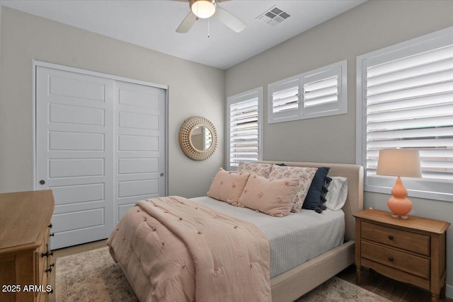 5860 E Sanford St, Mesa, AZ 85215 - bedroom with visible vents, a closet, a ceiling fan, and wood finished floors