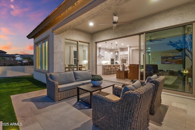 5860 E Sanford St, Mesa, AZ 85215 - patio terrace at dusk with an outdoor living space and a ceiling fan