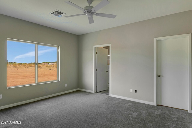 carpeted empty room featuring ceiling fan