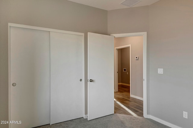 unfurnished bedroom with a closet and hardwood / wood-style flooring