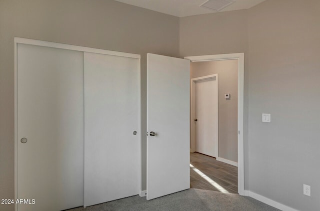 unfurnished bedroom with a closet and carpet