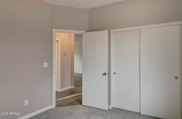 unfurnished bedroom with wood-type flooring and a closet