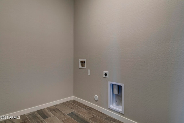 clothes washing area featuring hookup for an electric dryer, hookup for a gas dryer, dark hardwood / wood-style flooring, and hookup for a washing machine