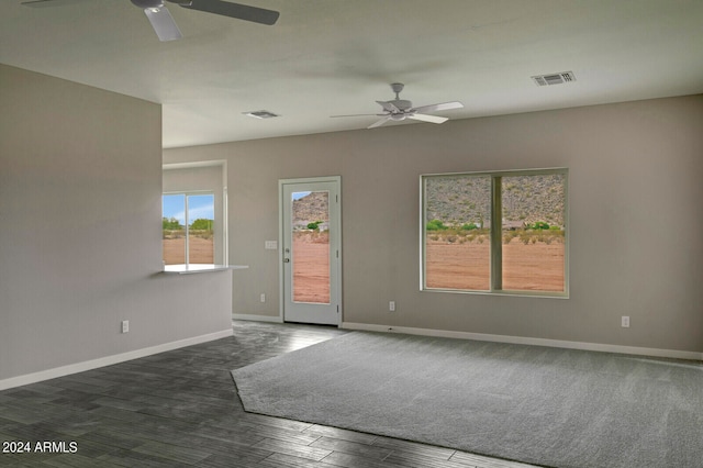 empty room featuring dark hardwood / wood-style floors and ceiling fan