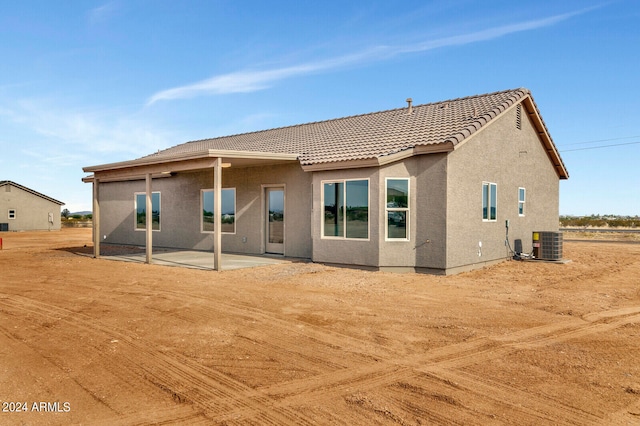 rear view of house with cooling unit and a patio