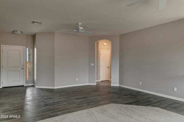 unfurnished room featuring ceiling fan and dark hardwood / wood-style flooring