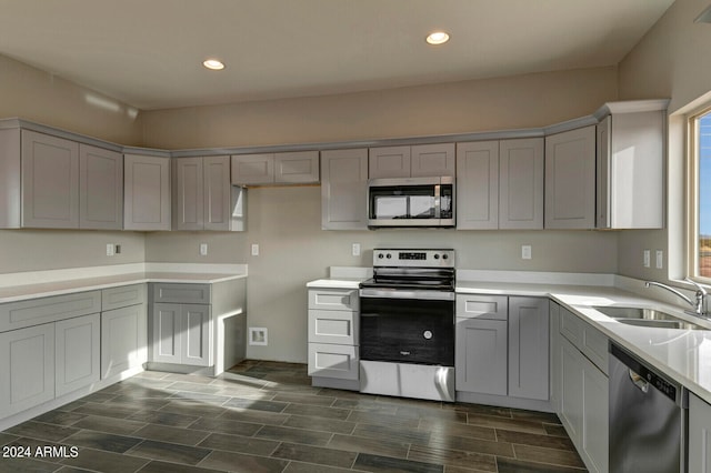 kitchen featuring sink, gray cabinetry, and stainless steel appliances