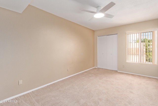 unfurnished bedroom with carpet floors, a closet, and ceiling fan