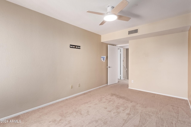 carpeted empty room featuring ceiling fan