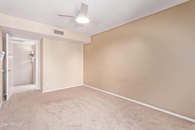 empty room with light colored carpet and ceiling fan