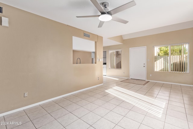 tiled empty room with ceiling fan