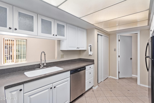 kitchen featuring sink, white cabinetry, stainless steel appliances, and light tile patterned floors