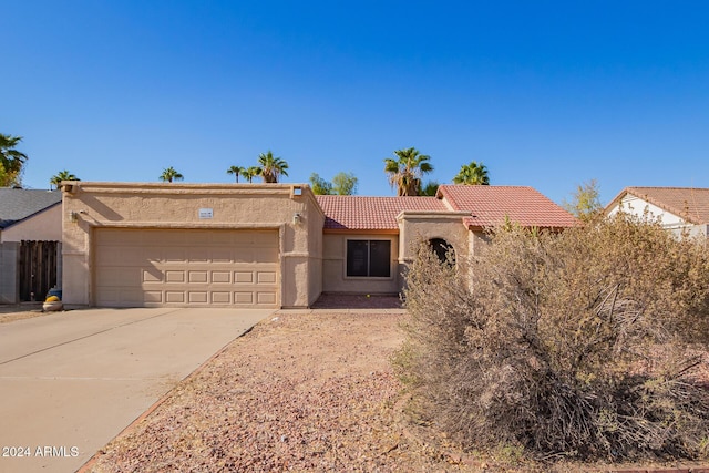 10096 N 63rd Ave, Glendale, AZ 85302 - view of front of home featuring stucco siding, a garage, a tile roof, and concrete driveway