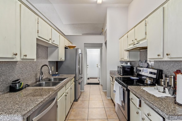 kitchen featuring sink, stainless steel appliances, a textured ceiling, decorative backsplash, and light tile patterned floors