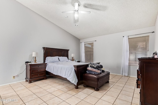 tiled bedroom with a textured ceiling, ceiling fan, and vaulted ceiling