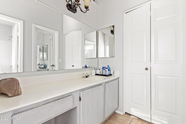 bathroom with vanity, tile patterned floors, and a notable chandelier