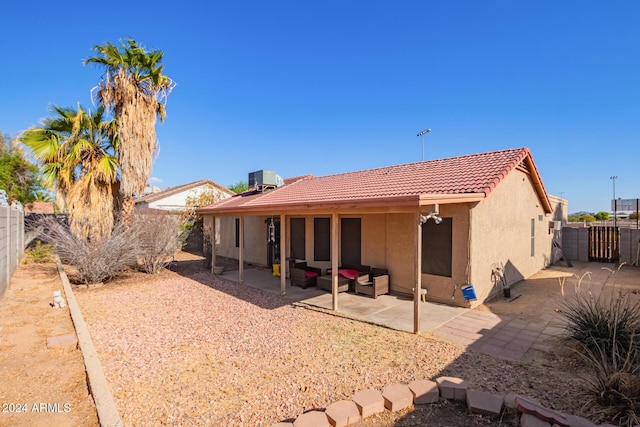 back of property with an outdoor living space, central AC, and a patio area