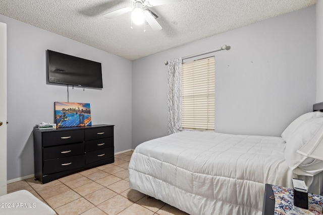 tiled bedroom featuring ceiling fan and a textured ceiling