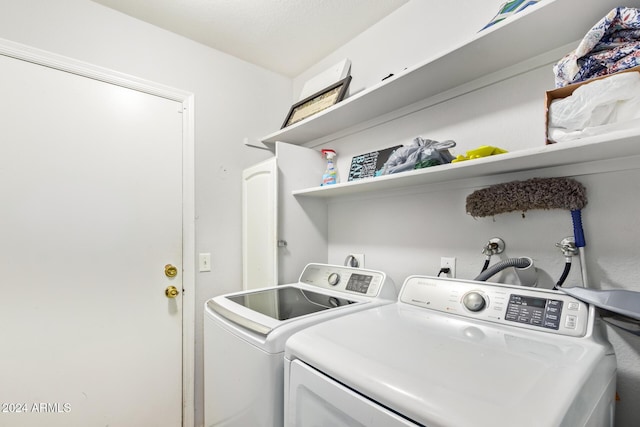 clothes washing area with washing machine and dryer