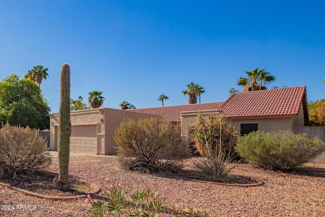 10096 N 63rd Ave, Glendale, AZ 85302 - view of front of house featuring stucco siding, a tiled roof, and an attached garage