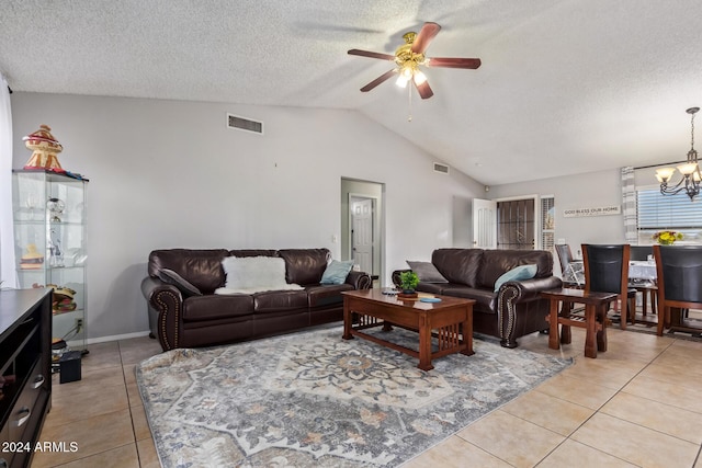 tiled living room with ceiling fan with notable chandelier, lofted ceiling, and a textured ceiling