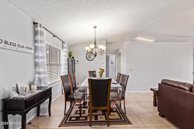 tiled dining space featuring a notable chandelier, lofted ceiling, and a textured ceiling